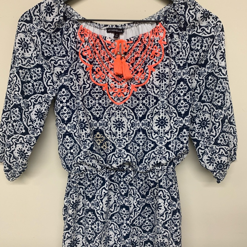 Navy printed romper with orange stitching.